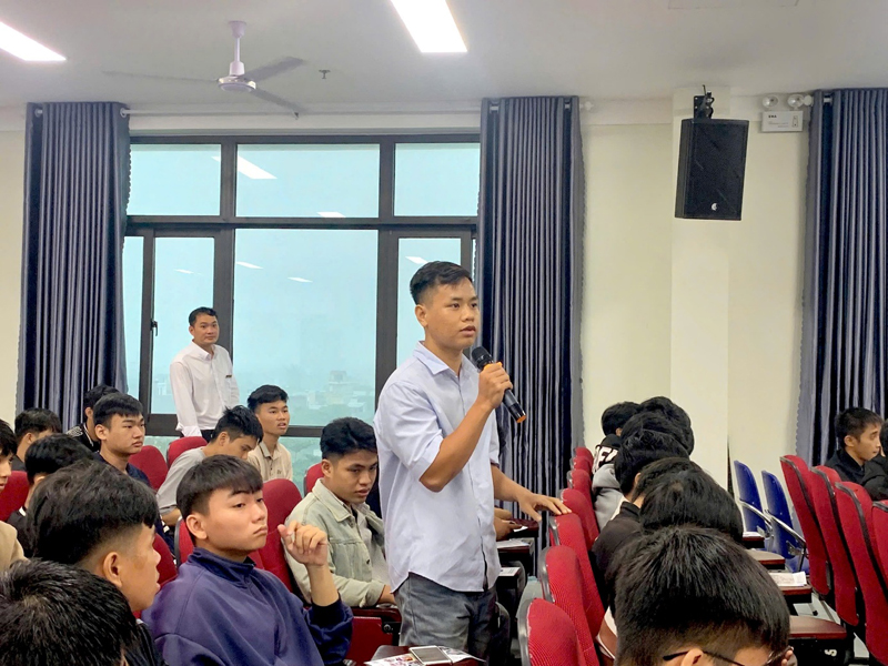 A person standing in front of a group of peopleDescription automatically generated